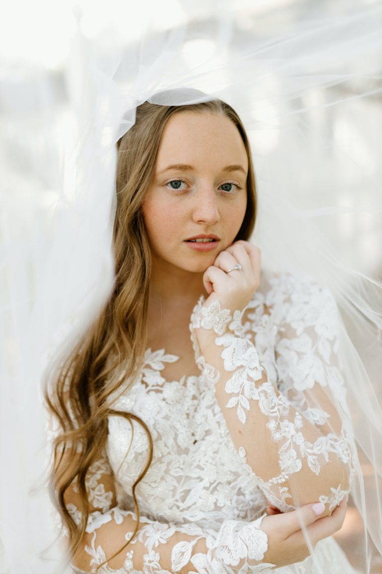 Bride who is posing in front of the church she was married in.